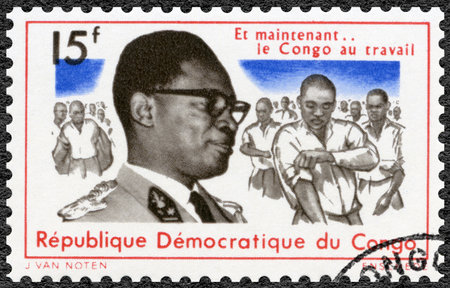 CONGO - CIRCA 1966: A stamp printed in Republic of the Congo shows Joseph Desire Mobutu (1930-1996), Sese Seko Kuku Ngbendu Wa Za Banga, and publicizing the Back to Work, campaign, men rolling up sleeves, president Congo, circa 1966のeditorial素材