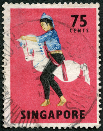 SINGAPORE - CIRCA 1968: A stamp printed in Singapore shows Tarian Kuda Kepang, Javanese dance, circa 1968のeditorial素材