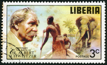 LIBERIA - CIRCA 1975: A stamp printed in Liberia shows elephant and tribesmen poling boat, series Dr. Albert Schweitzer (1875-1965), medical missionary, 100th anniversary of the birth, circa 1975のeditorial素材