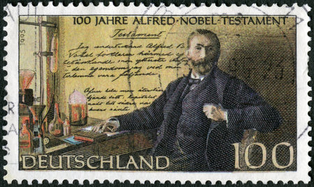 GERMANY - CIRCA 1995: A stamp printed in Germany shows Alfred Bernhard Nobel (1833-1896), in laboratory, Nobel Prize Fund Established, circa 1995のeditorial素材