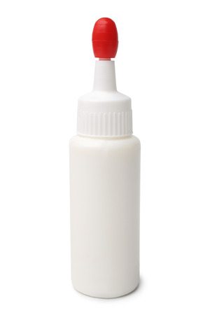 Bottle of glue with cap white backgroundの写真素材