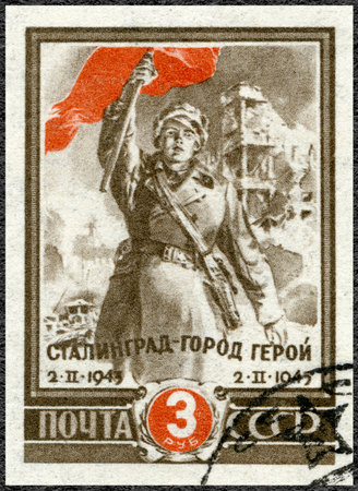 USSR - CIRCA 1945: A stamp printed in USSR shows soldier with red flag, Battle of Stalingrad, hero city, Second anniversary of victory at Stalingrad, circa 1945のeditorial素材