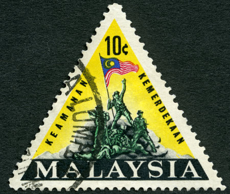 MALAYSIA - CIRCA 1965: A stamp printed by Malaysia shows National Monument, Kuala Lumpur, The National Monument by US sculptor Felix W de Weldon commemorates the struggle of the people of Malaysia for peace and for freedom from communism, circa 1965のeditorial素材