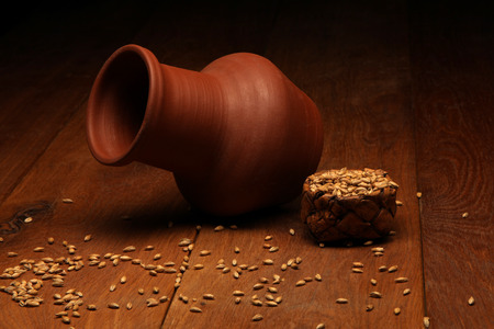 Still-life with wheat grains and cruse on wooden backgroundの写真素材