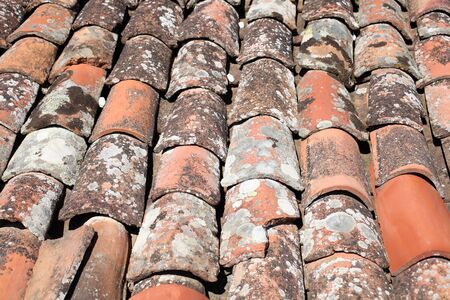 Closeup of old red clay roof tiles, for backgrounds or texturesの写真素材