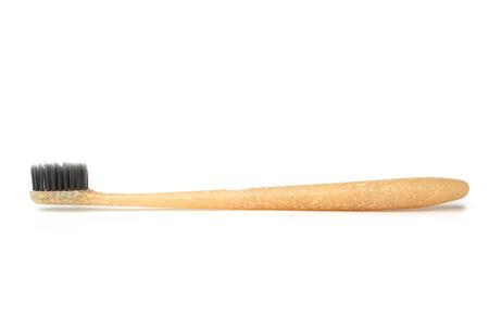 Bamboo coal tooth-brush on white background