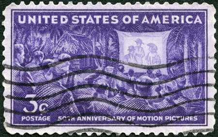 UNITED STATES OF AMERICA - CIRCA 1944: A stamp printed in USA shows Motion Picture Showing for the Armed Forces in South Pacific, circa 1944のeditorial素材