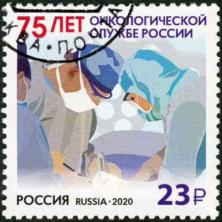 RUSSIA - CIRCA 2020: A stamp printed in Russia shows Doctors and surgery operation, 75th Anniversary of the oncologic service in Russia, circa 2020のeditorial素材