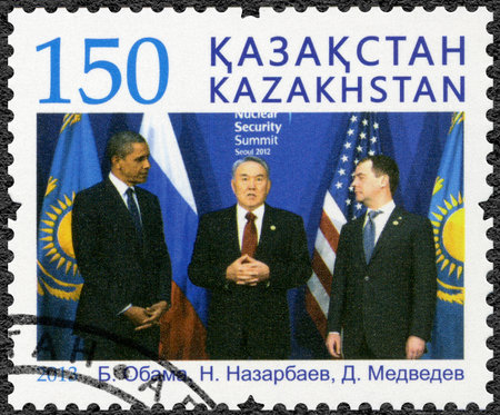 KAZAKHSTAN - CIRCA 2013: A stamp printed in Kazakhstan shows Nazarbayev, Obama, Medvedev, politicians, Presidents, circa 2013のeditorial素材