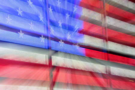 US flag in New York City at night. Blurred zoom effect.の写真素材