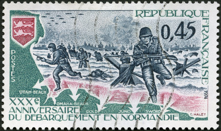 FRANCE - CIRCA 1974: A stamp printed in France shows Americans Landing in Normandy and Arms of Normandy, D-Day, 30th anniversary of the liberation of France from the Nazis, circa 1974のeditorial素材