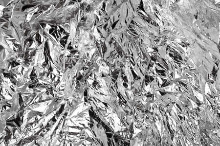 Silver crumpled foil, for backgrounds or texturesの写真素材