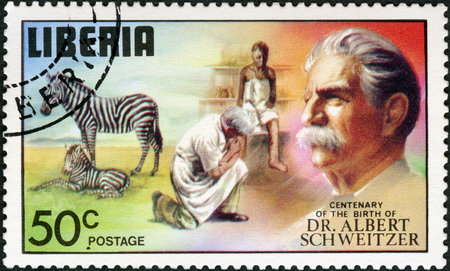 LIBERIA - CIRCA 1975: A stamp printed in Liberia shows zebra and colt, doctor examination at clinic, series Dr. Albert Schweitzer (1875-1965), medical missionary, 100th anniversary of the birth, circa 1975のeditorial素材