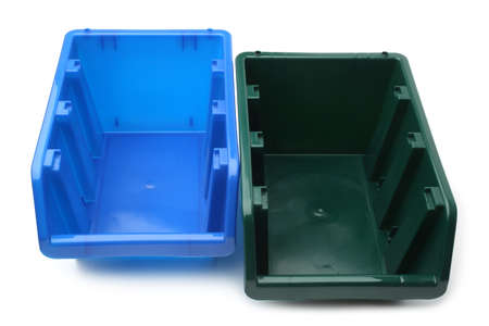 Blue and green plastic crates on white background