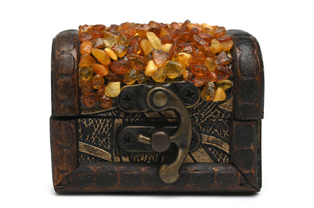 Old wooden casket inlaid amber on white backgroundの写真素材