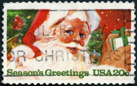 MOSCOW, RUSSIA - APRIL 02, 2023: A stamp printed in USA shows Gift and Santa Claus, Season Greeting, devoted Christmas, 1983のeditorial素材