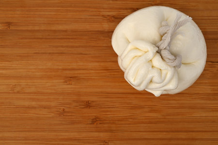 Creamy Italian traditional Burrata cheese on wooden boardの写真素材