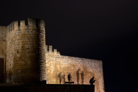 The ghostly silhouette of a man stood in front of the fortress wall at night. Derbent fortress wallの写真素材