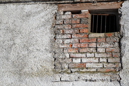 Old brick wall with latticed window, for backgrounds or texturesの写真素材