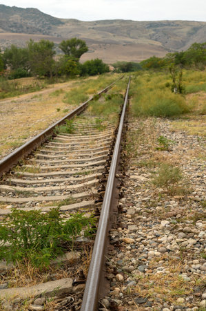 Railroad tracks by the mountains, vertical pictureの写真素材