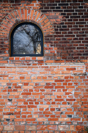 Red brick wall with window, for backgrounds or texturesの写真素材