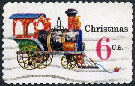 UNITED STATES OF AMERICA - CIRCA 1970: A stamp printed in USA shows Tin and Cast iron Locomotive, devoted Christmas, circa 1970のeditorial素材
