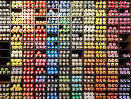 Close up view of the shelf with used multicolored graffiti spray cans. Art, artistic style. Inside shooting.の写真素材