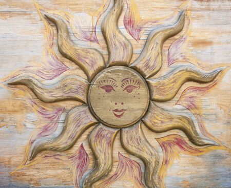 The image of the sun carved on a treeの写真素材