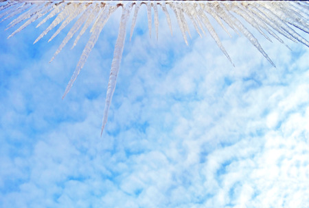 icicles hanging from the edge of the roofの写真素材