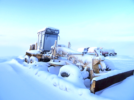 tractor in the snow is in a desert area