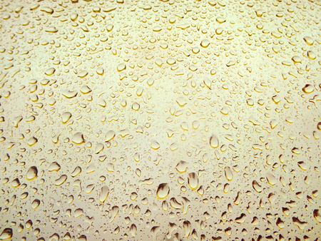 Close-up of water drops on glass surface as backgroundの写真素材