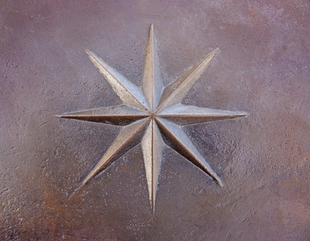 metal plate with the symbol of the compass rose of the winds, travel concept backgroundの写真素材