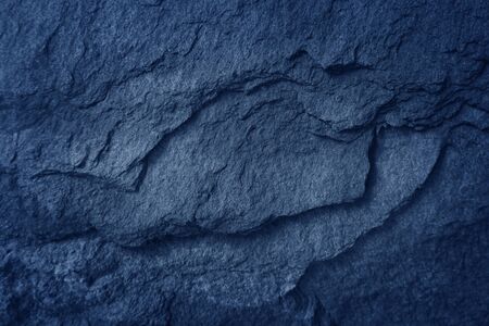 Dark blue slate background. Black stone texture.