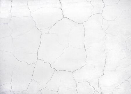 White wall with cracks as a background                               の写真素材
