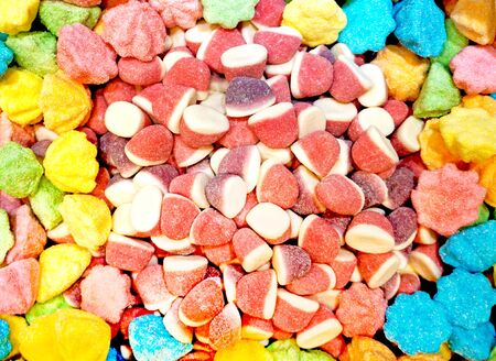 Background of candy in orange, yellow and blue, halloween colors for the holidaysの写真素材