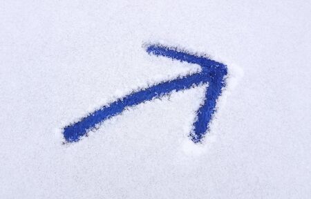 Blue arrow pointing right drawn into snow.