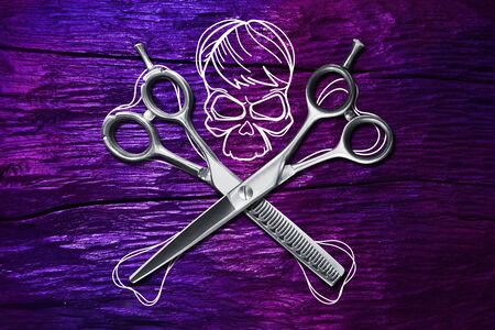 hairdressing different scissors isolated with skull and bones on colorful backgroundの写真素材