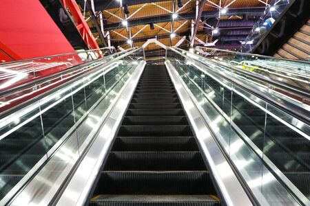 The interior of the airport. Escalator going up and down.                                   の写真素材