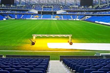 MOSCOW, RUSSIA - JANUARY 8, 2020: Lawn care at the stadium "VTB arena" . Lighting of the lawn for rapid growth of grassのeditorial素材