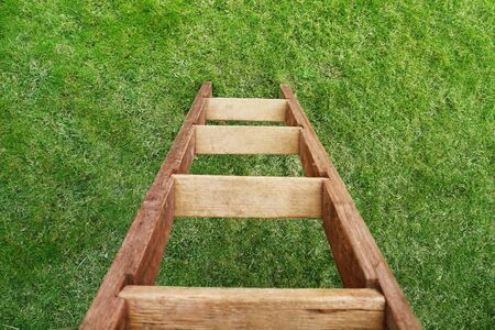 Top view from the old wooden staircase down to the grassの写真素材