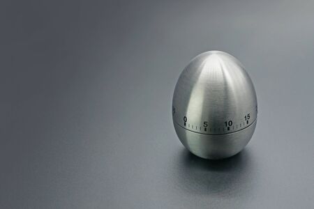 An egg-shaped alarm clock. An iron egg on a dark background.                               の写真素材