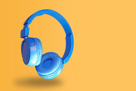 Blue headphones isolated on a yellowの写真素材