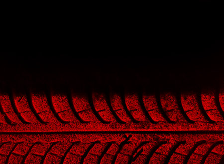 Red trace of tire on the black backgroundの写真素材