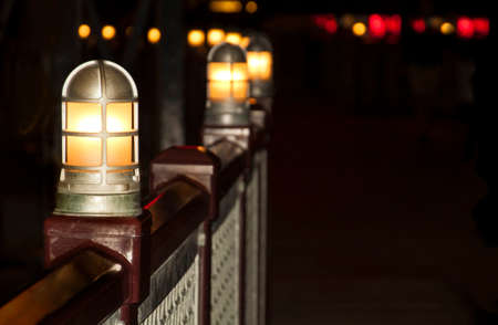 lanterns on the fence of the bridge over the river