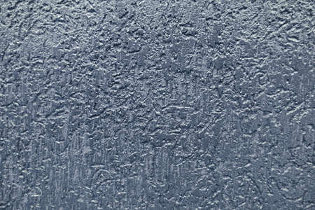 Light gray paint textured wall closeup. Blue background.