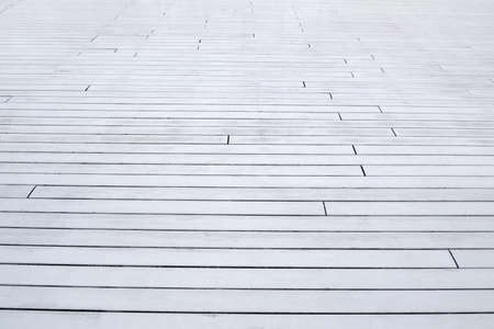 the wooden floor is made of white planks extending into the distanceの写真素材