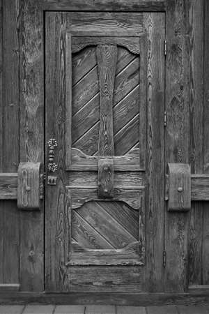 Detail of hinge on old wooden door in historical cityの写真素材