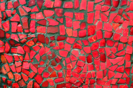 Red mosaic tiles of irregular sizes arranged in a background motif. Space for text.の写真素材