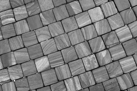 The texture of the paved tile on the bottom of the street. Natural brick squared stone floor