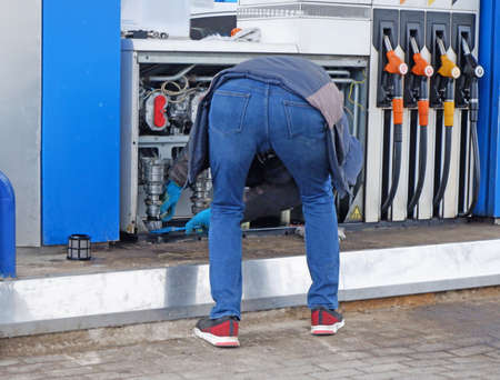 The man at the gas station close-up, nobody, man repairs the fuel pump. Refueling. Gas station. Petrol. Petrol.の写真素材